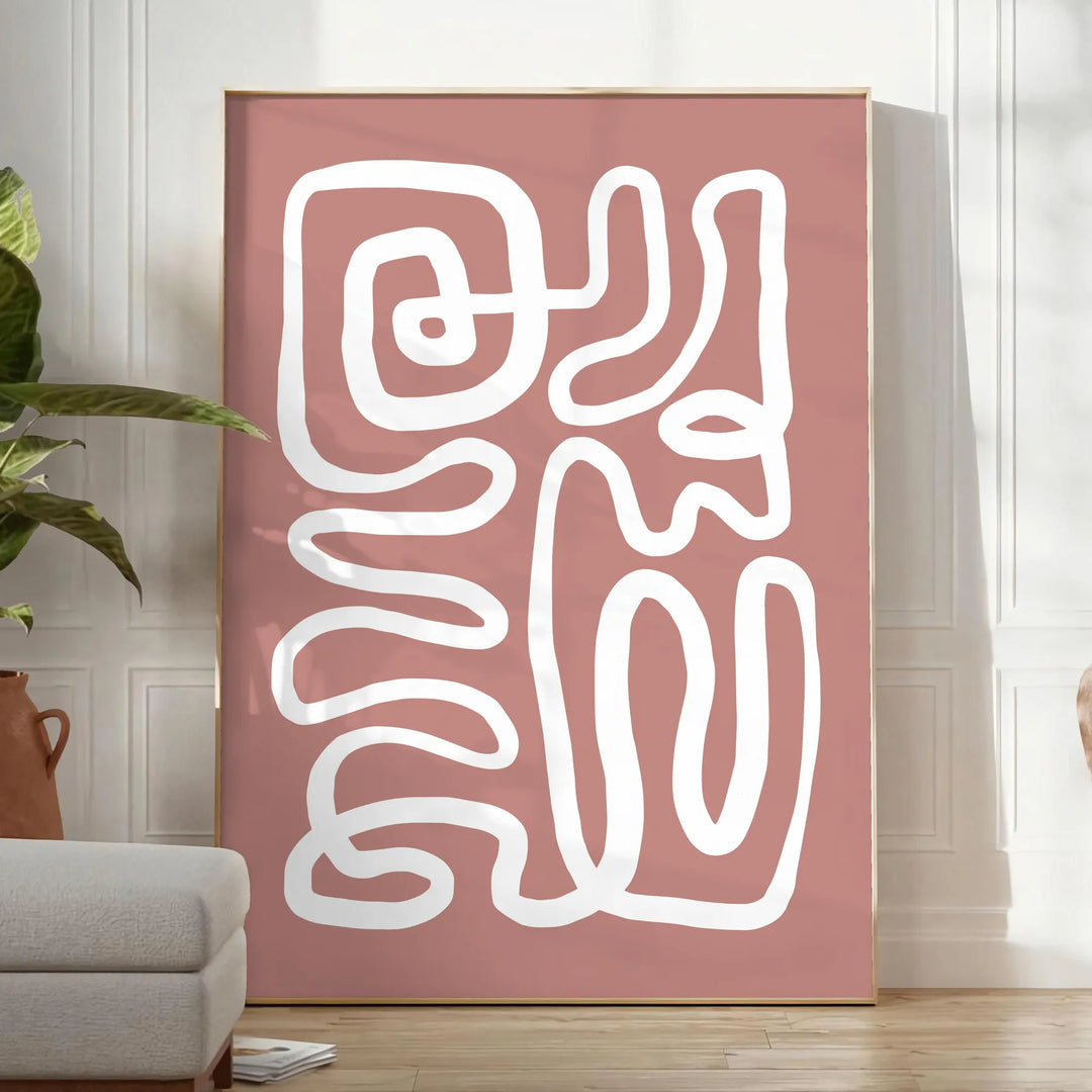 Minimalist paper-cut artwork in white and brown, layered abstract design - in a bright minimalist room with a plant and an armchair