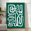 White and green paper-cut botanical artwork on minimalist poster - in a bright minimalist room with a plant and an armchair