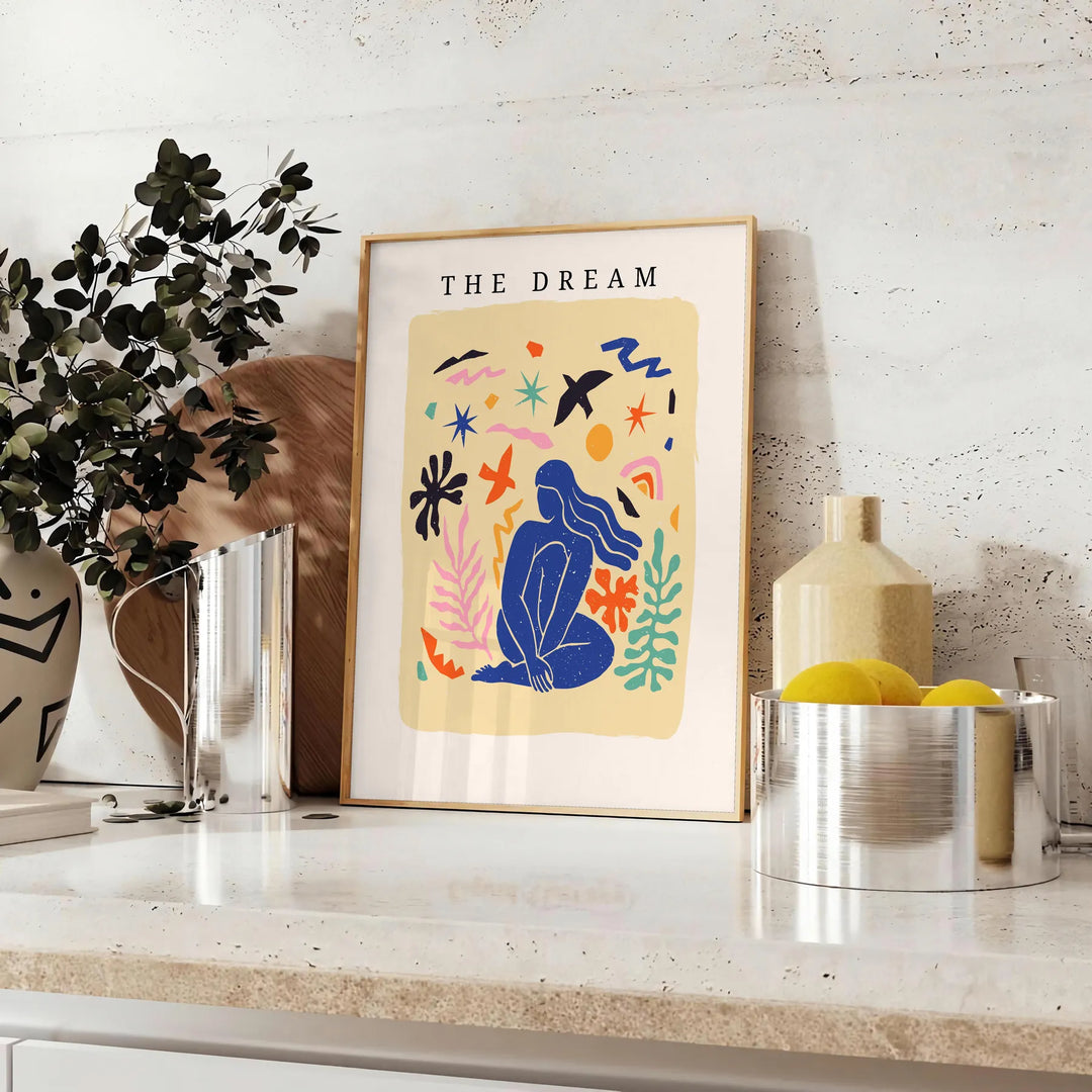 Abstract paper-cut design featuring layered orange and blue shapes - styled on a counter with eucalyptus and a bowl of lemons
