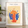 Abstract design featuring layered orange and blue paper-cut shapes - in a bright minimalist room with a plant and an armchair