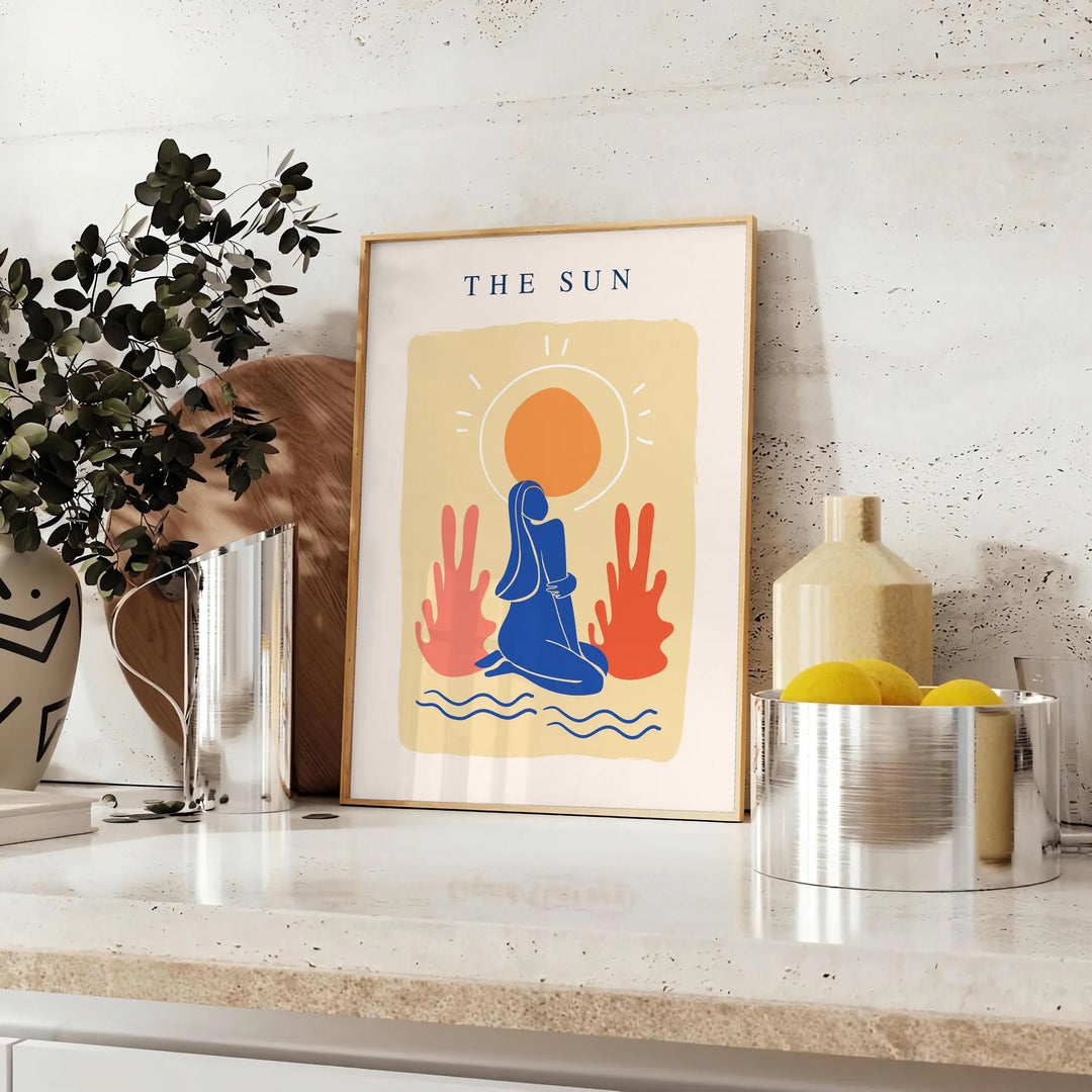 Poster showing layered papier découpé space artwork in orange and blue - styled on a counter with eucalyptus and a bowl of lemons