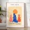 Poster showing layered papier découpé space artwork in orange and blue - in a bright minimalist room with a plant and an armchair