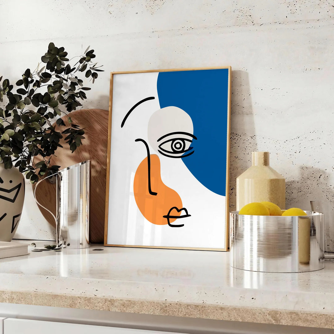 Brown and black paper-cut abstract poster with layered minimalist shapes - styled on a counter with eucalyptus and a bowl of lemons