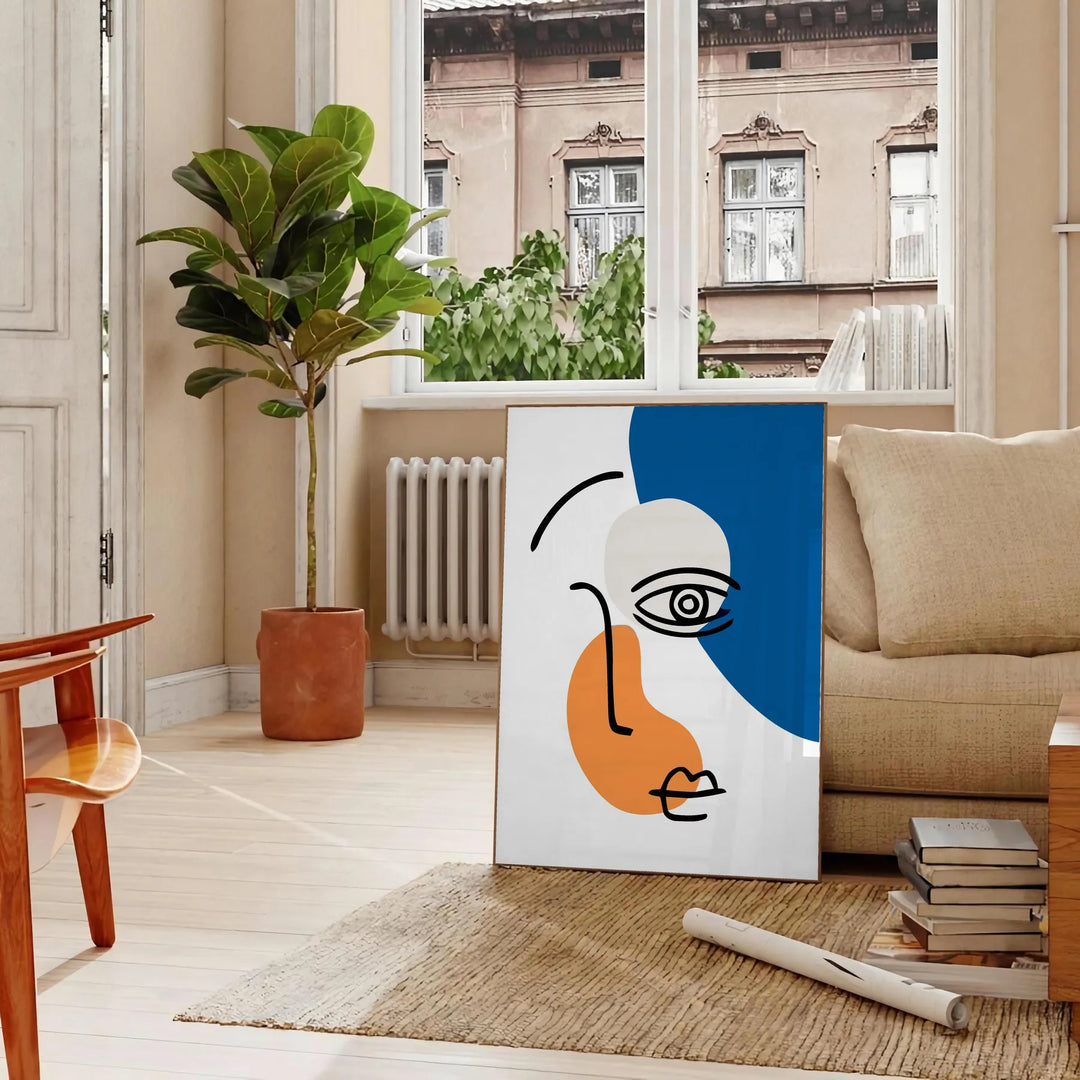 Brown and black paper-cut abstract poster with layered minimalist shapes - in a Parisian living room with a sofa and a fig plant