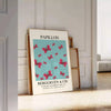 Maximalist poster featuring a colorful butterfly against a dark background - leaning on a herringbone floor against a white panelled wall