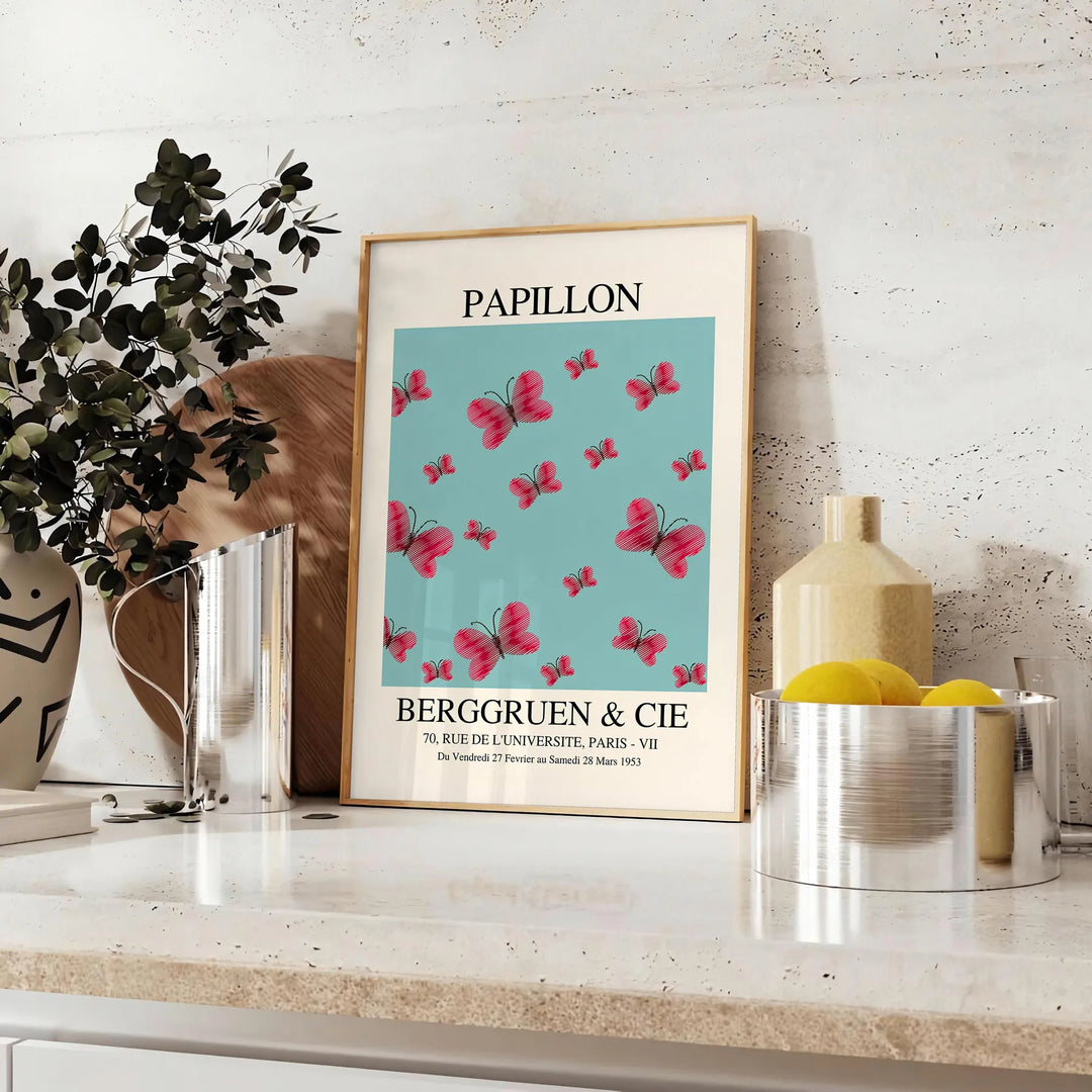 Maximalist poster featuring a colorful butterfly against a dark background - styled on a counter with eucalyptus and a bowl of lemons