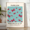 Maximalist poster featuring a colorful butterfly against a dark background - in a bright minimalist room with a plant and an armchair