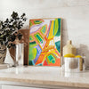 Graphic illustration of Paris with orange and blue tones - styled on a counter with eucalyptus and a bowl of lemons