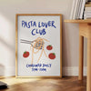 blue and white poster featuring 'Pasta Lover Club' text with pasta illustrations - beside a round wooden side table with books