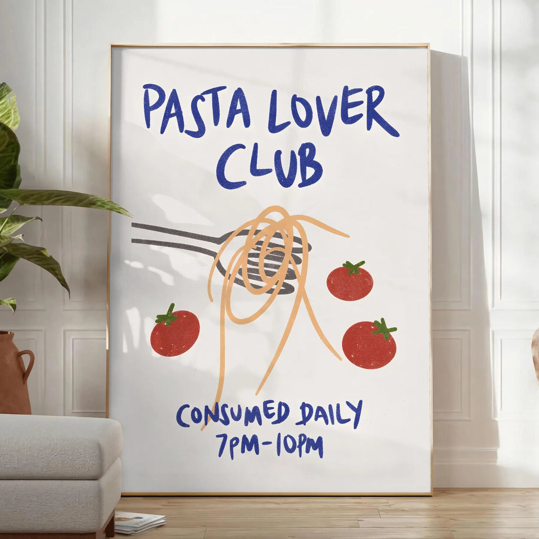 blue and white poster featuring 'Pasta Lover Club' text with pasta illustrations - in a bright minimalist room with a plant and an armchair