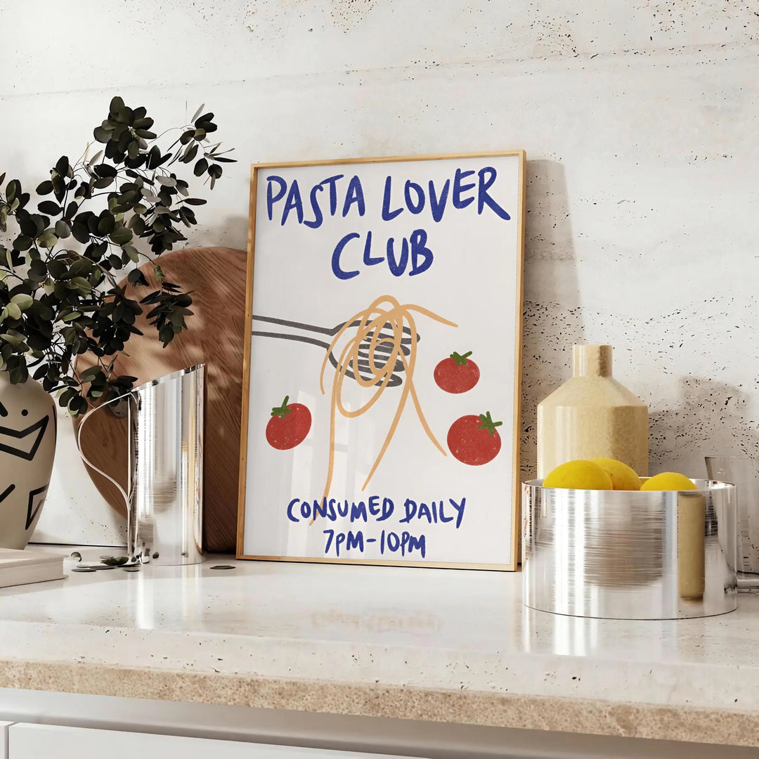 Minimalist kitchen print featuring 'Pasta Lover Club' in white and gray tones - styled on a counter with eucalyptus and a bowl of lemons