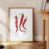A colorful pepper illustration with rich brown and green tones - beside a round wooden side table with books