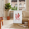 A colorful pepper illustration with rich brown and green tones - in a Parisian living room with a sofa and a fig plant