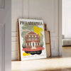 Illustration of Philadelphia skyline with green and brown tones - leaning on a herringbone floor against a white panelled wall