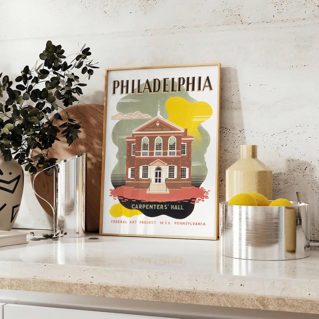 Illustration of Philadelphia skyline with green and brown tones - styled on a counter with eucalyptus and a bowl of lemons