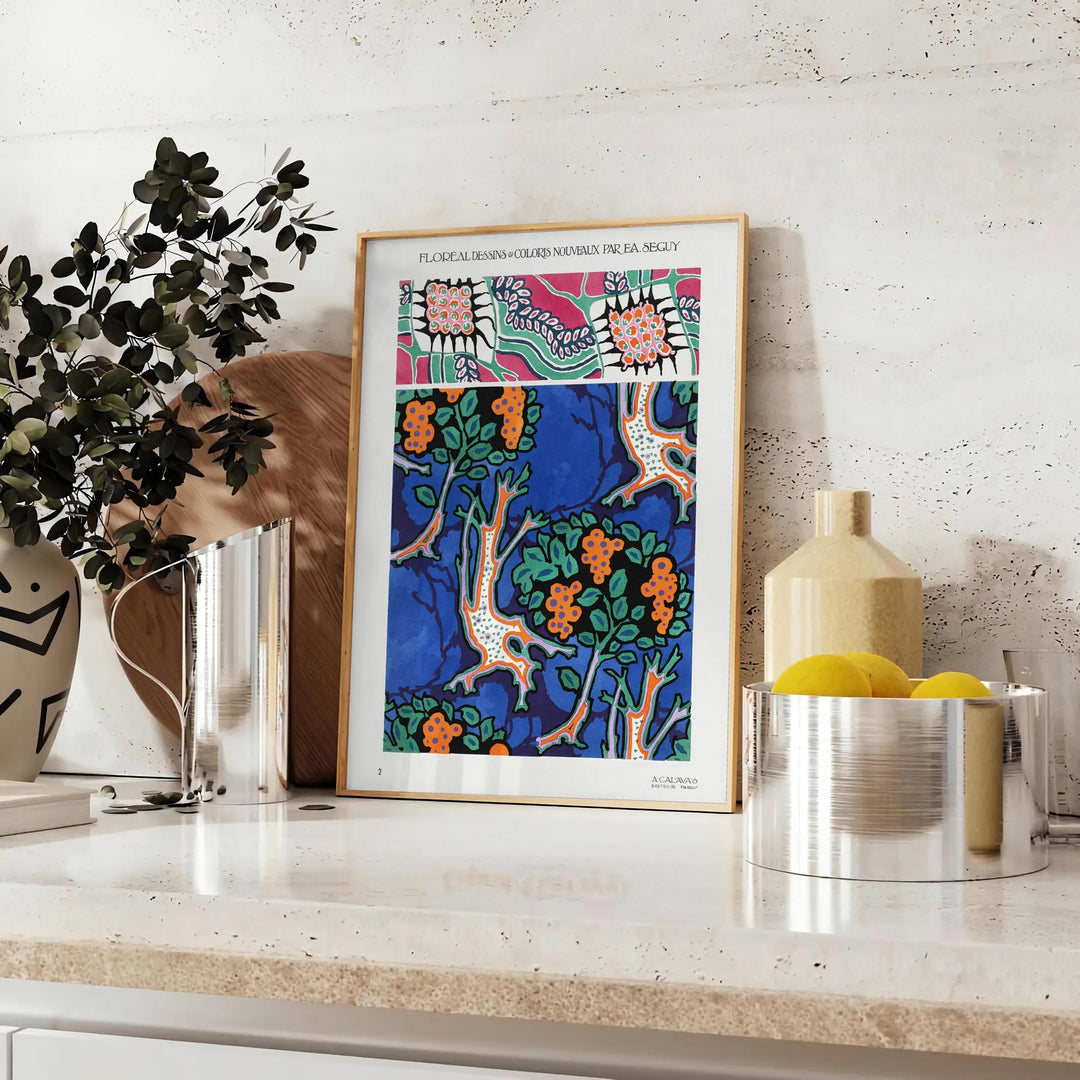 Botanical illustration featuring orange and blue plants by EA Séguy - styled on a counter with eucalyptus and a bowl of lemons