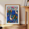Botanical illustration featuring orange and blue plants by EA Séguy - beside a round wooden side table with books
