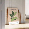 A botanical illustration featuring various green plants on a textured gray background - leaning on a herringbone floor against a white panelled wall