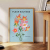 A lush green plant illustration with blue accents against a light background - beside a round wooden side table with books