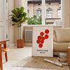 A colorful illustration of tomatoes and kitchen utensils inspired by Naples, Italy - in a Parisian living room with a sofa and a fig plant