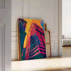 Dynamic pop art design with orange and blue hues, featuring abstract shapes - leaning on a herringbone floor against a white panelled wall