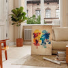 Pop Art poster featuring a dynamic space scene with rich brown and vivid orange tones - in a Parisian living room with a sofa and a fig plant