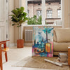 Pop art depiction of an eye with green and blue tones - in a Parisian living room with a sofa and a fig plant