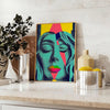 Colorful pop art depiction of a woman with orange and green tones - styled on a counter with eucalyptus and a bowl of lemons