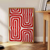 Abstract space scene with bold orange and red tones - beside a round wooden side table with books