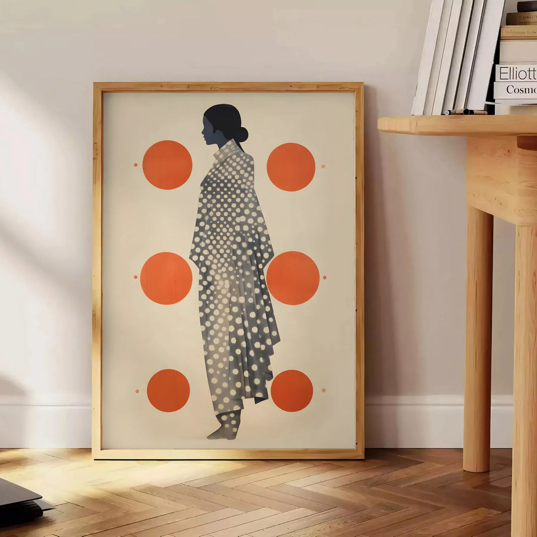 Stylish gray poster with vibrant orange abstract shapes - beside a round wooden side table with books