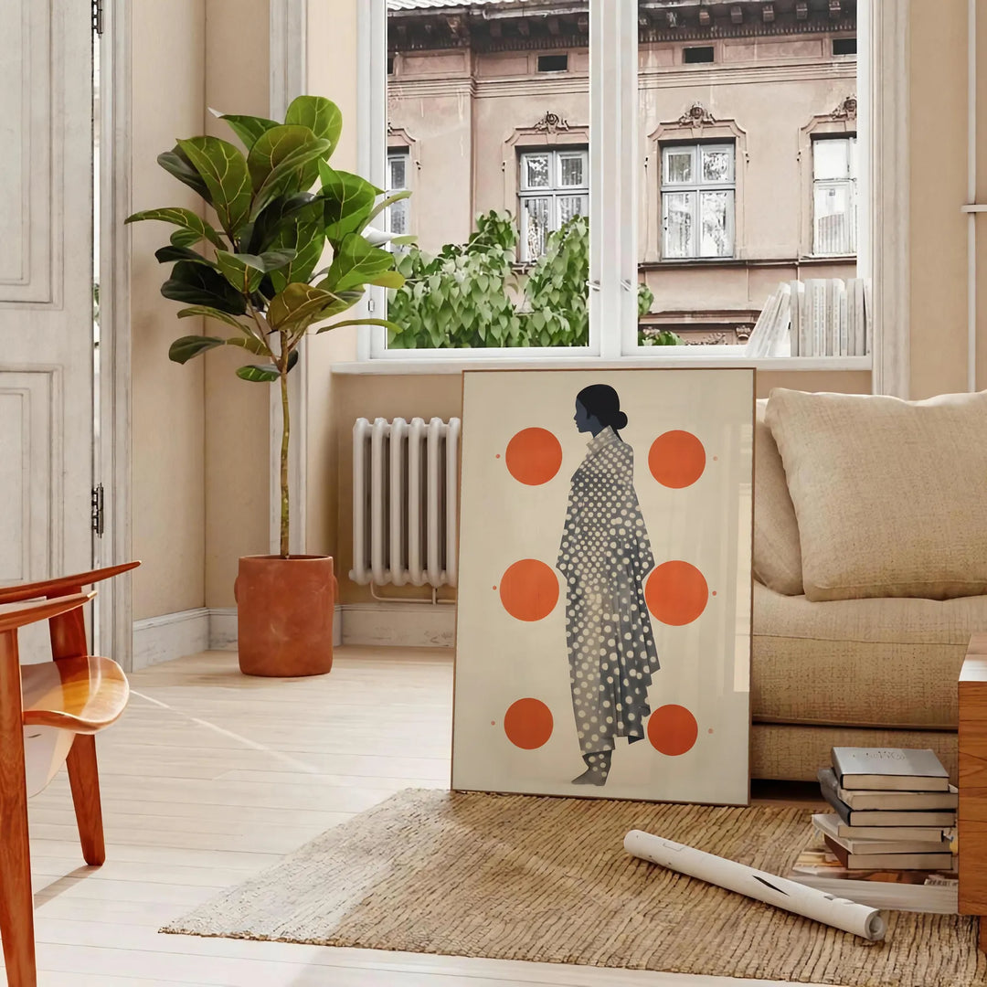 Stylish gray poster with vibrant orange abstract shapes - in a Parisian living room with a sofa and a fig plant