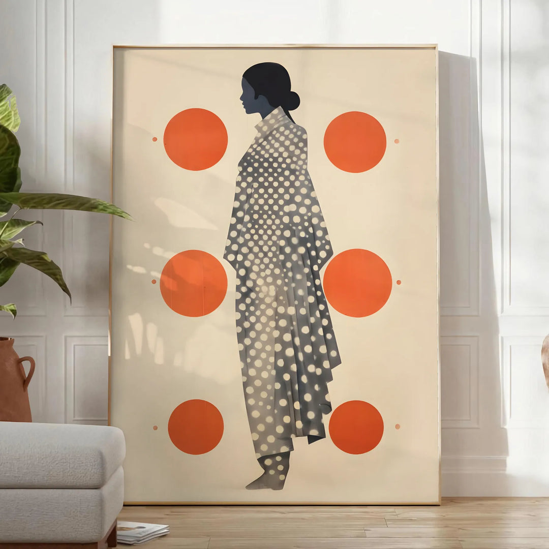Stylish gray poster with vibrant orange abstract shapes - in a bright minimalist room with a plant and an armchair