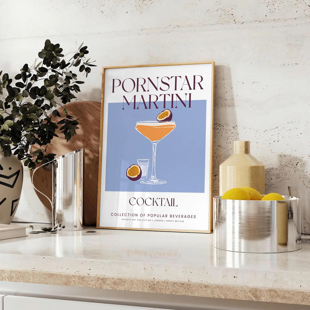 Illustration of a Pornstar Martini cocktail with orange and blue hues - styled on a counter with eucalyptus and a bowl of lemons