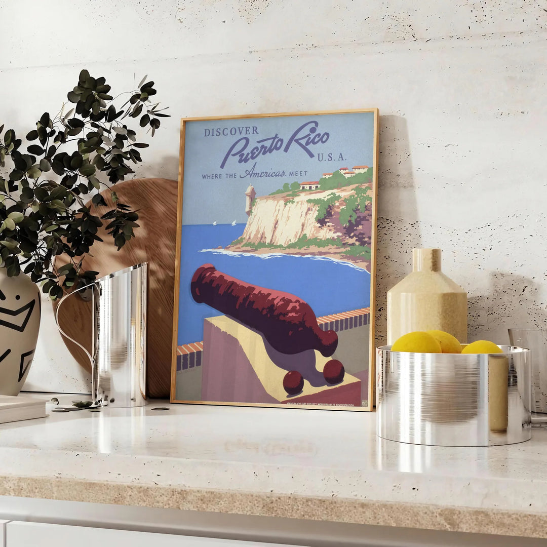 A travel poster featuring Puerto Rico's tropical landscape in earthy browns and greens - styled on a counter with eucalyptus and a bowl of lemons