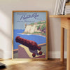 A travel poster featuring Puerto Rico's tropical landscape in earthy browns and greens - beside a round wooden side table with books