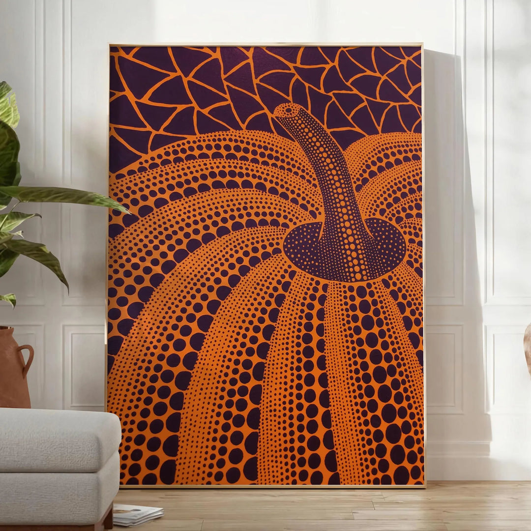 Yayoi Kusama pumpkin artwork with rich brown and green hues - in a bright minimalist room with a plant and an armchair