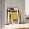 A pumpkin pattern in Yayoi Kusama's signature polka dot style with yellow and black colors - leaning on a herringbone floor against a white panelled wall