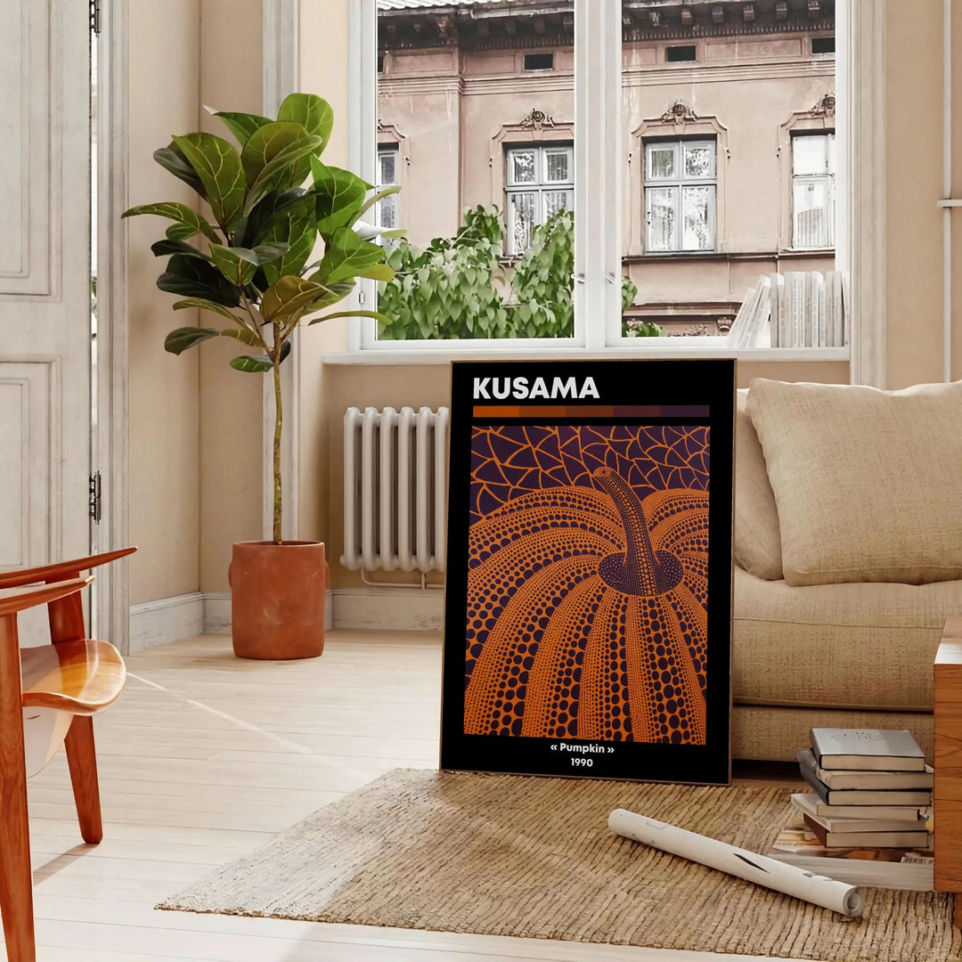 Orange pumpkin covered in black polka dots in Yayoi Kusama's style - in a Parisian living room with a sofa and a fig plant