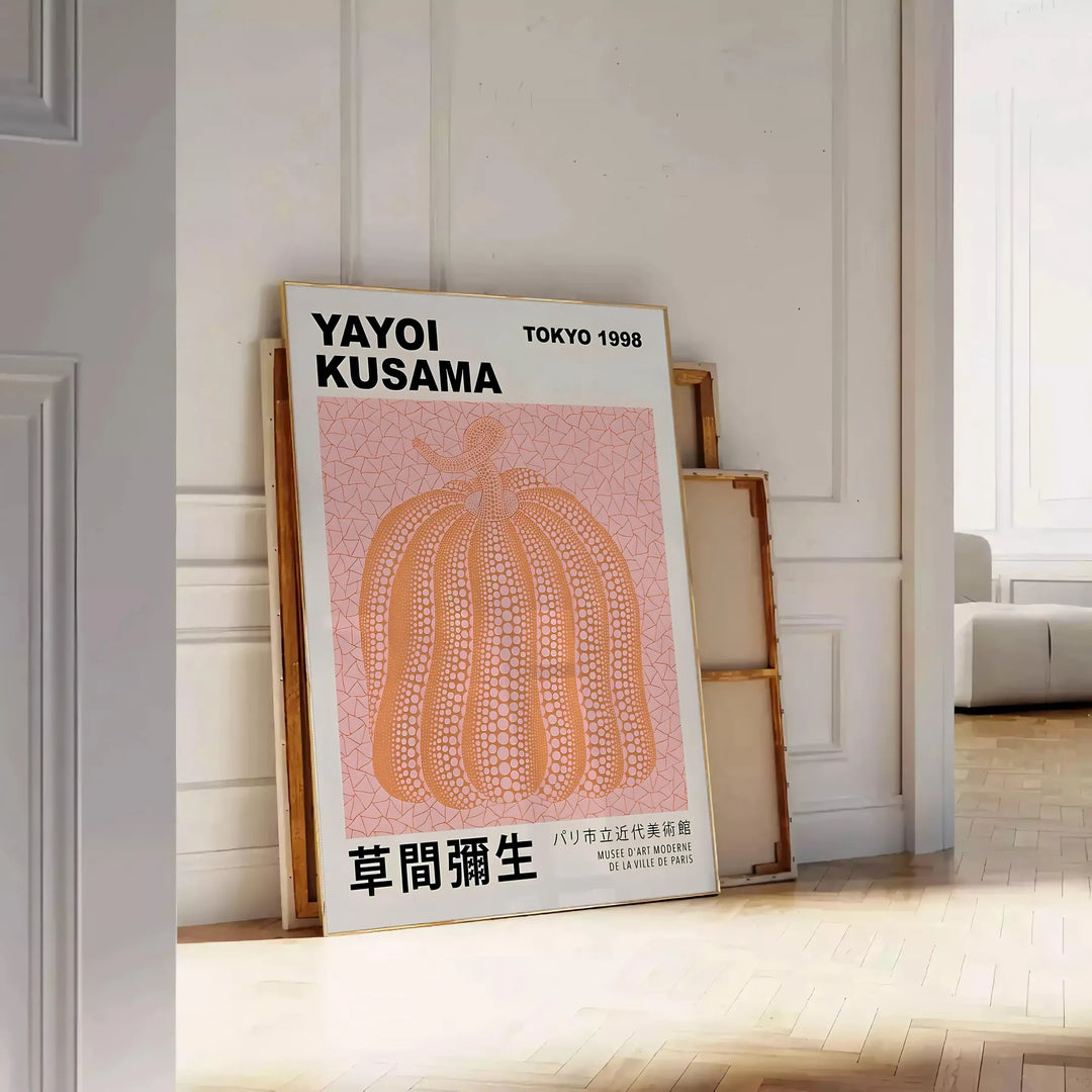 A pumpkin pattern in Yayoi Kusama's signature polka dot style with black and brown tones - leaning on a herringbone floor against a white panelled wall