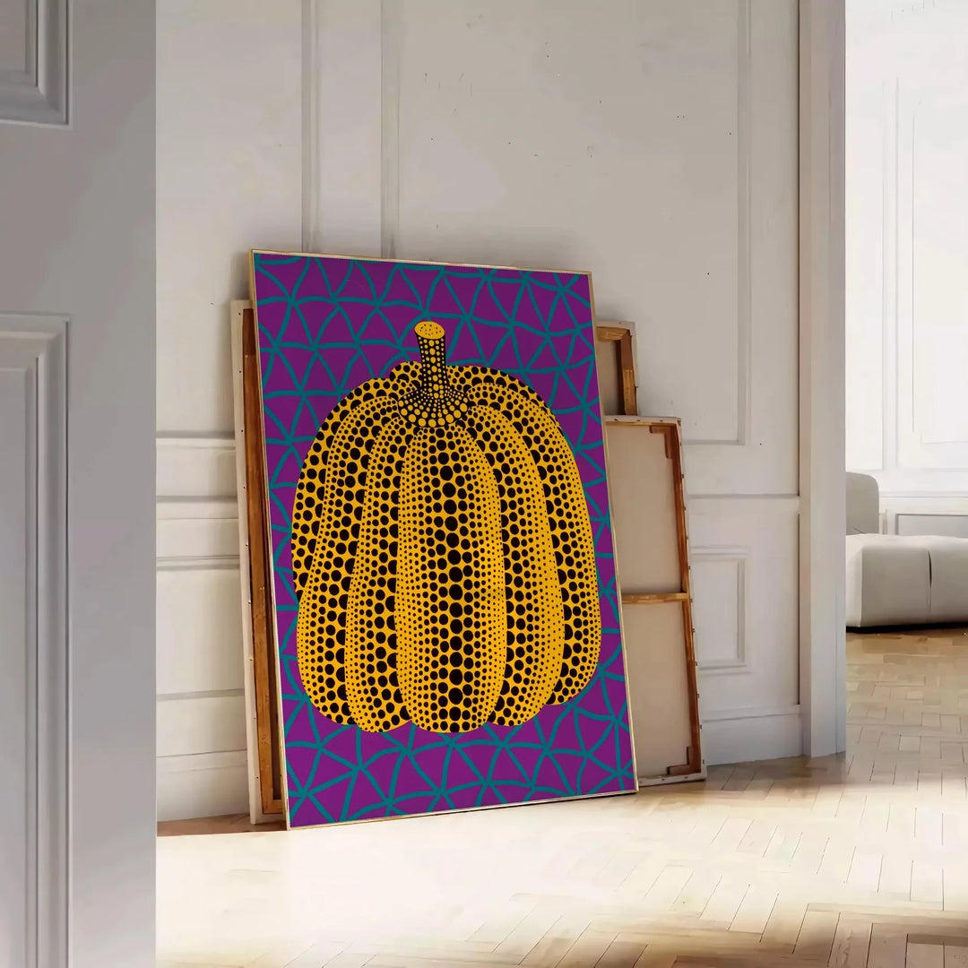 Colorful pumpkin pattern with polka dots by Yayoi Kusama - leaning on a herringbone floor against a white panelled wall