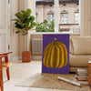 Colorful pumpkin pattern with polka dots by Yayoi Kusama - in a Parisian living room with a sofa and a fig plant