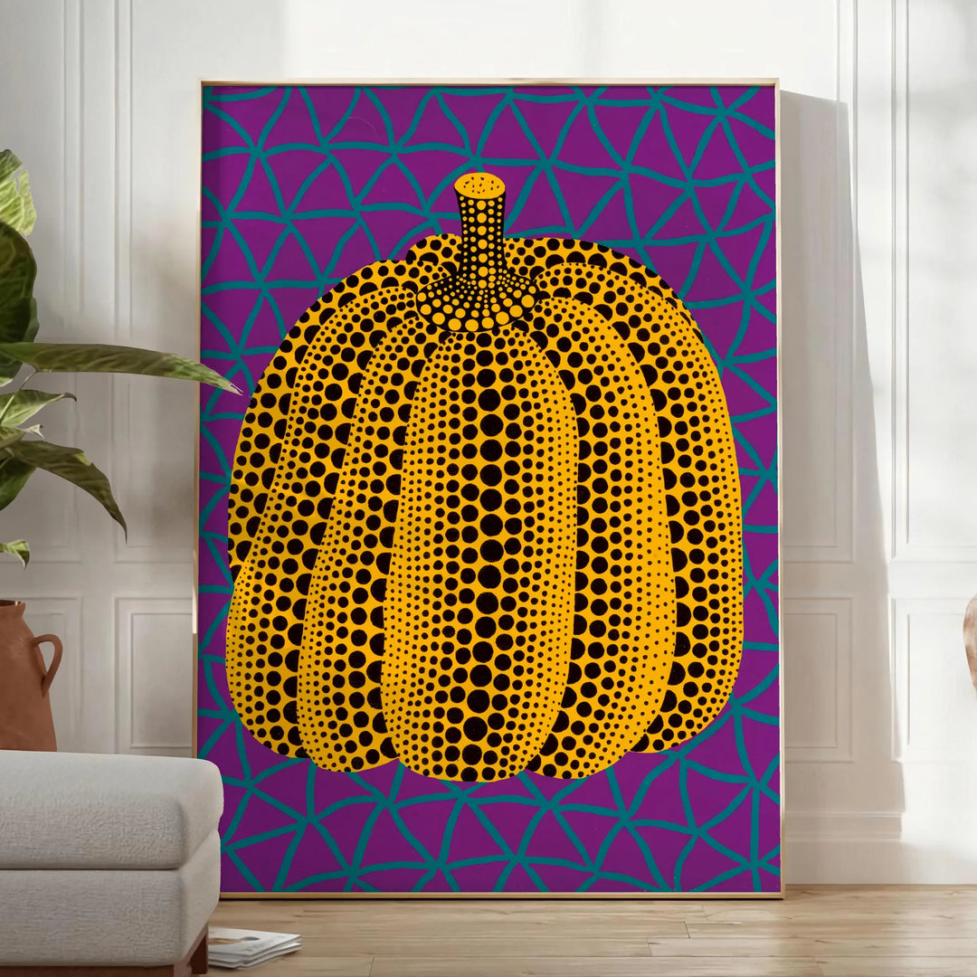 Colorful pumpkin pattern with polka dots by Yayoi Kusama - in a bright minimalist room with a plant and an armchair