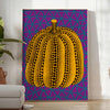 Colorful pumpkin pattern with polka dots by Yayoi Kusama - in a bright minimalist room with a plant and an armchair