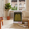 Yellow pumpkin with black polka dots in Yayoi Kusama's signature style - in a Parisian living room with a sofa and a fig plant