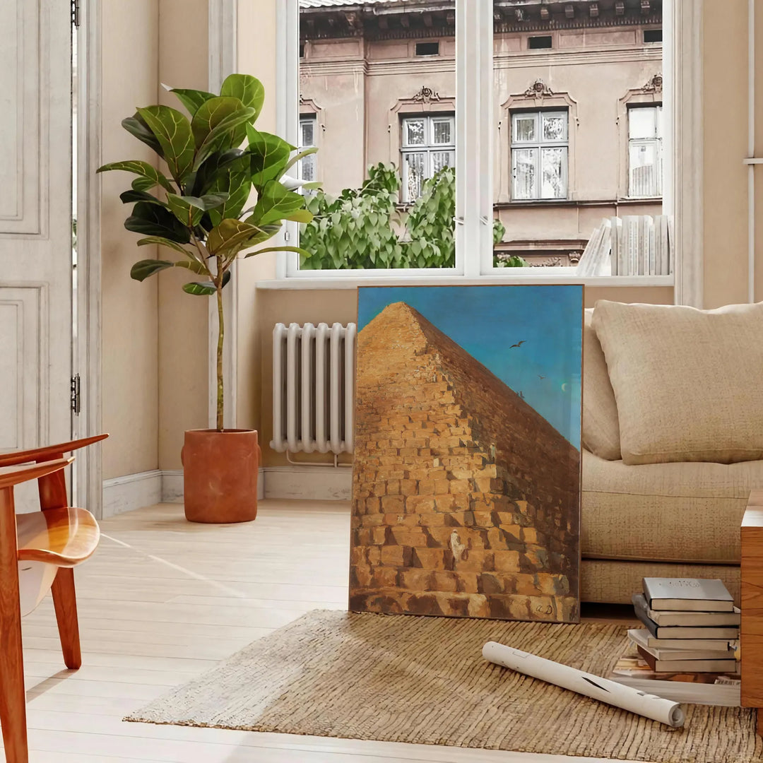 Vintage artwork featuring a pyramid with green and orange hues - in a Parisian living room with a sofa and a fig plant