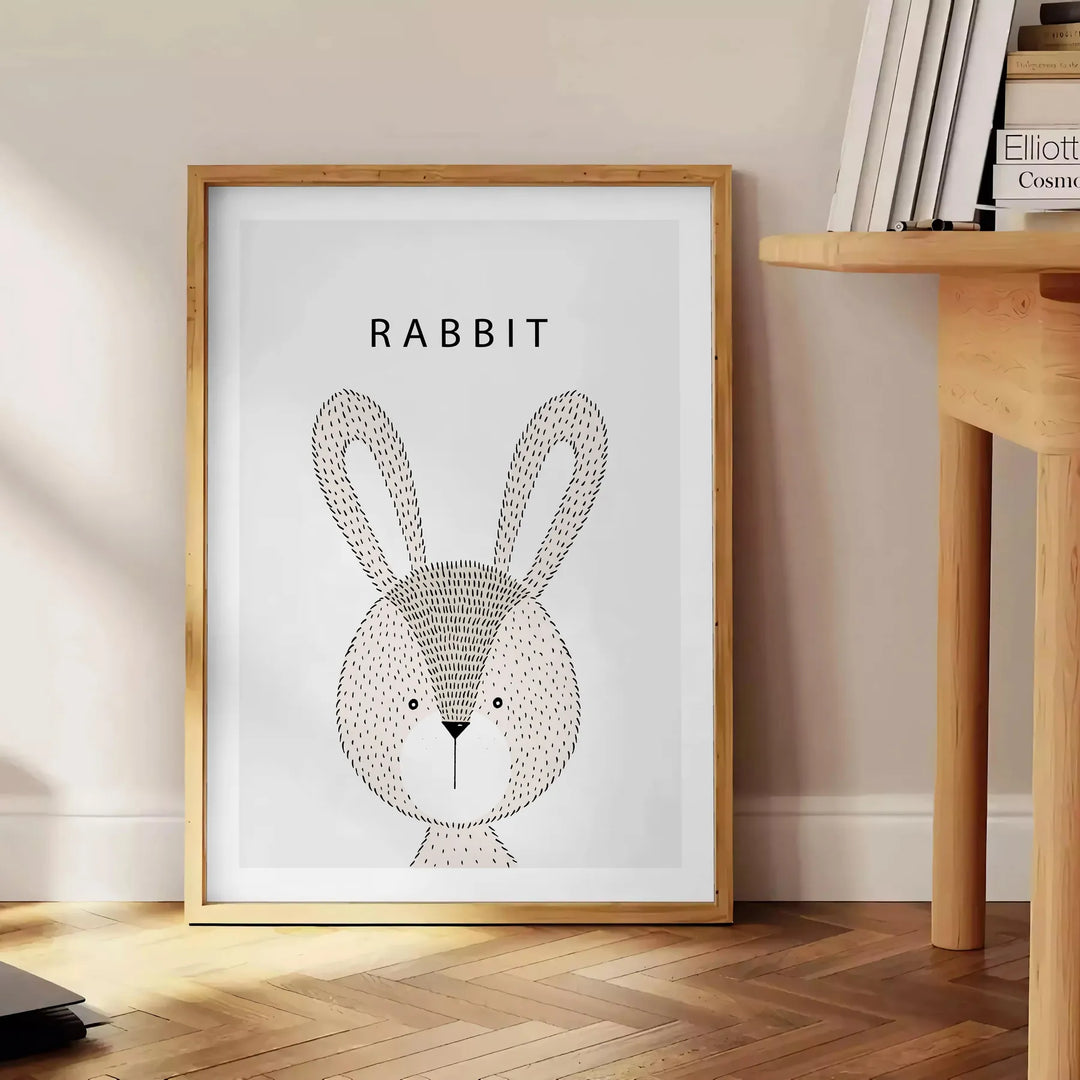 A rabbit in a serene gray and black color palette - beside a round wooden side table with books
