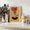 Illustration of a ramen kitchen with bold yellow and black colors - styled on a counter with eucalyptus and a bowl of lemons