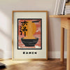 Illustration of a ramen kitchen with bold black and orange colors - beside a round wooden side table with books