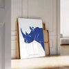 A rhinoceros standing in a natural habitat with blue and black tones - leaning on a herringbone floor against a white panelled wall