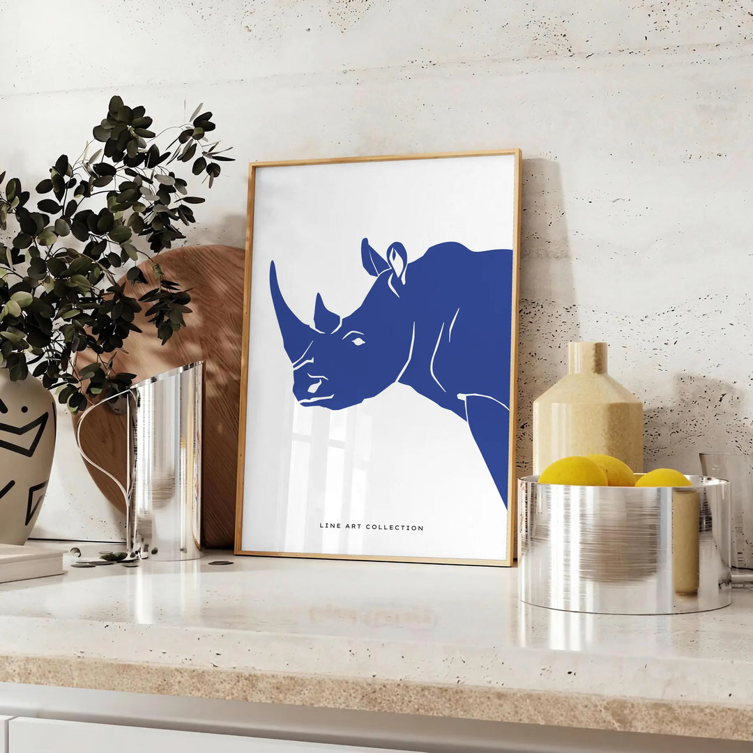 A rhinoceros standing in a natural habitat with blue and black tones - styled on a counter with eucalyptus and a bowl of lemons